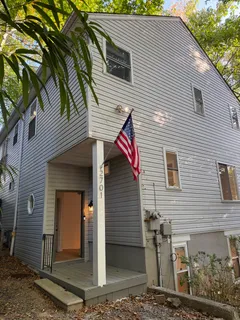 a view of a house with a door and wooden walls