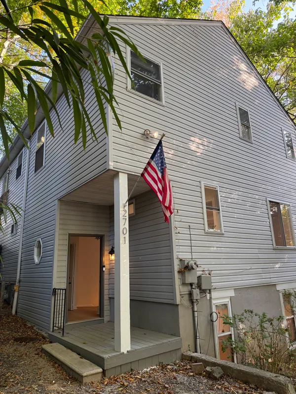 a view of a house with a door and wooden walls