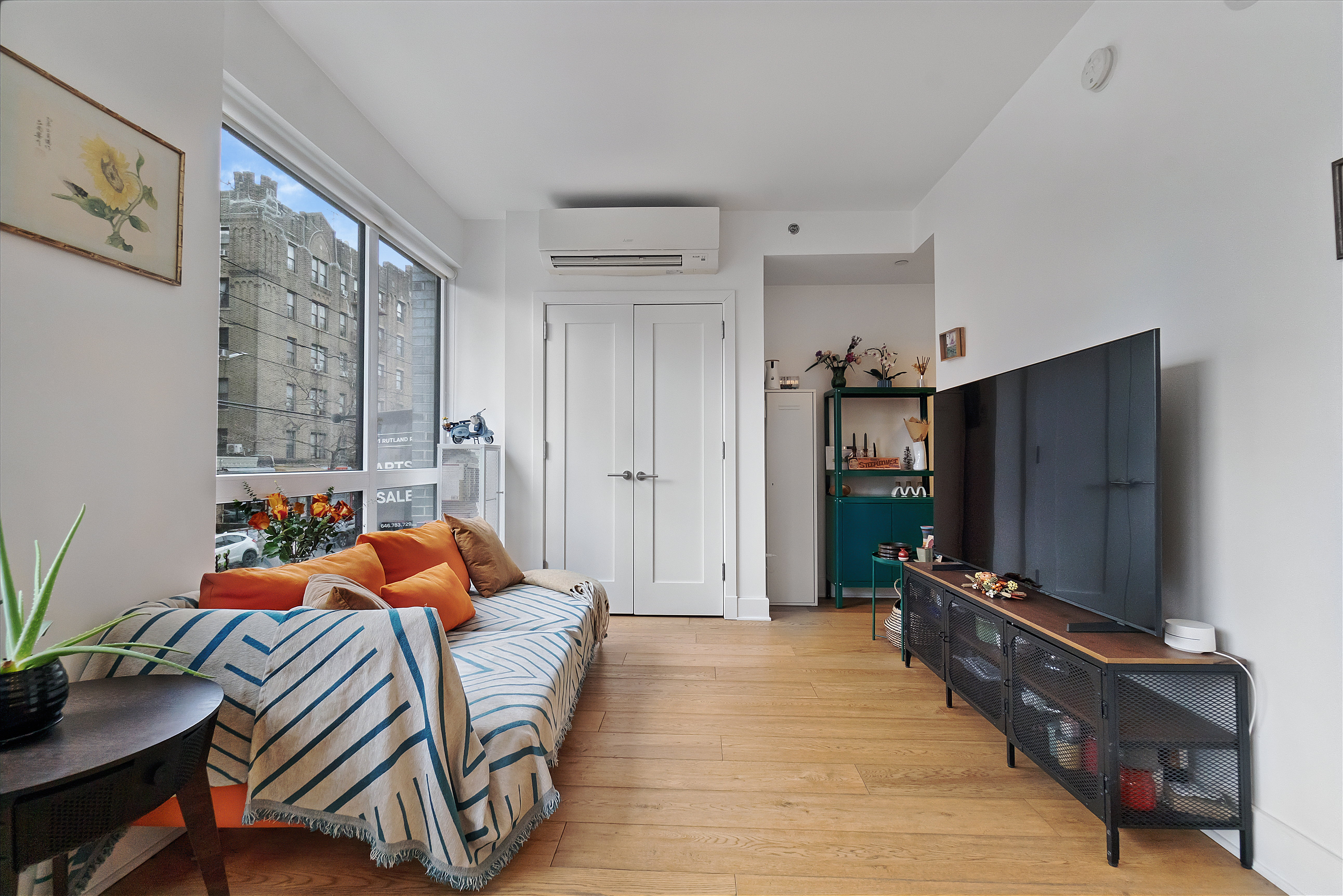 401 Rutland Road, Unit 2C Brooklyn, NY 11203 - Photo 1 of 13 a bedroom with furniture and a flat screen tv