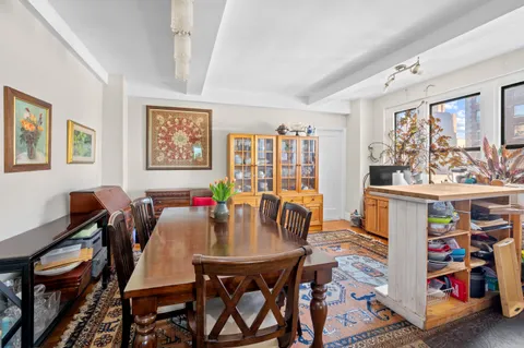 a view of a dining room with furniture and a window