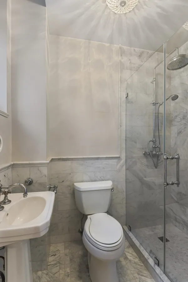 a bathroom with a sink toilet and shower