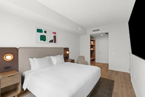 a bedroom with a bed and a flat screen tv