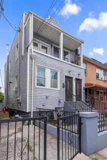 a front view of a house with a fence