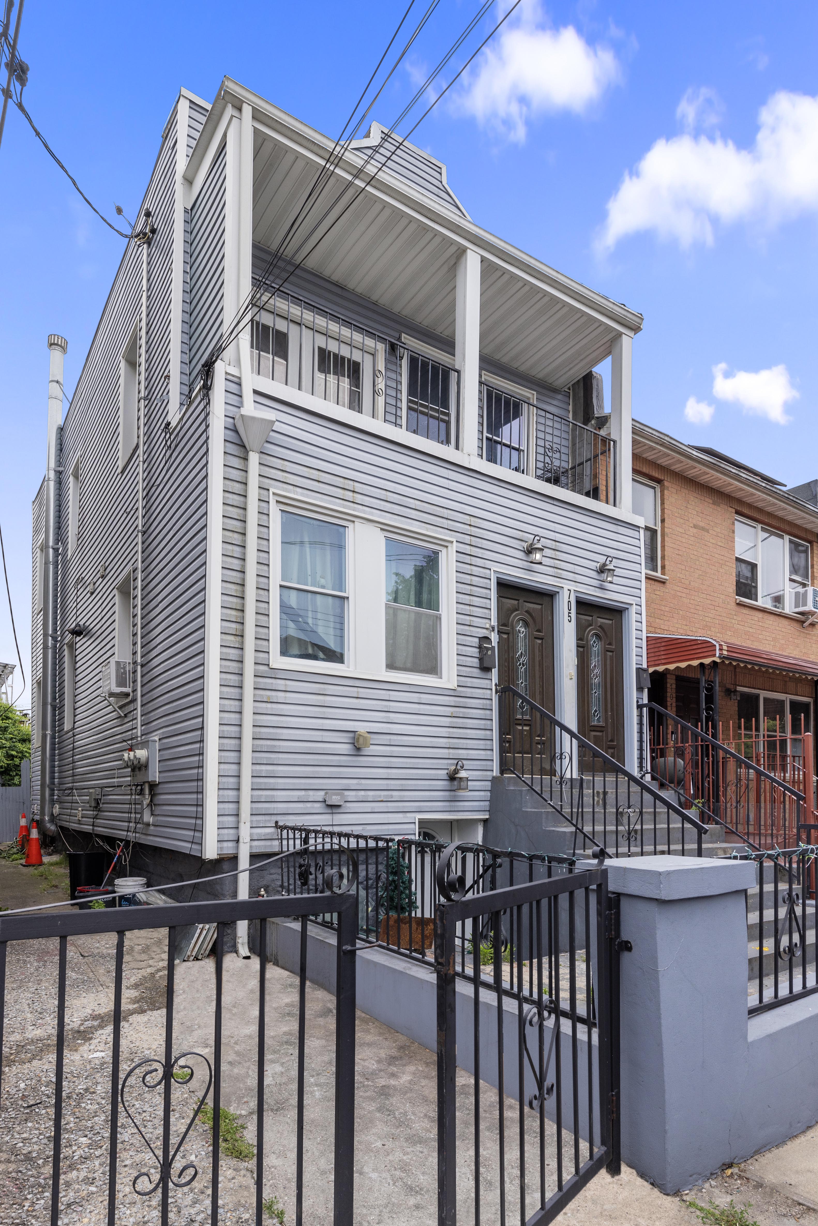 705 Schenck Avenue Brooklyn, NY 11207 - Photo 2 of 8 a front view of a house with a fence