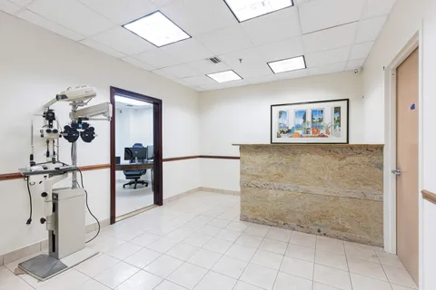 a view of a hallway with a mirror and furniture