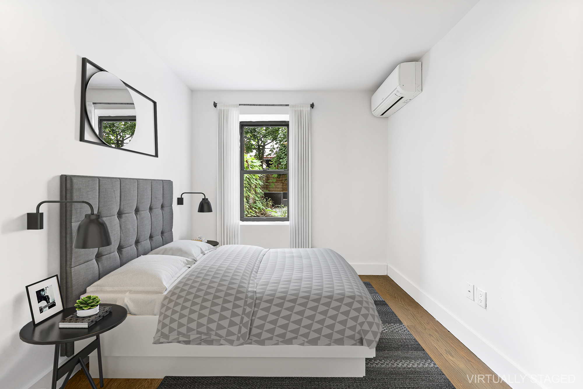 81 Eldert Street, Unit 1 Brooklyn, NY 11207 - Photo 7 of 9 a bedroom with a bed and a table in it