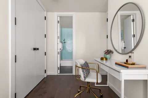 a room with table chair and a mirror