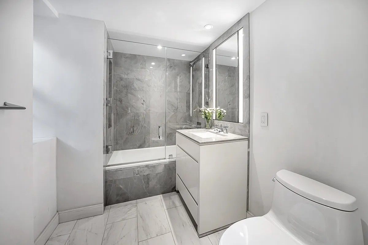 a bathroom with a sink a toilet and tub