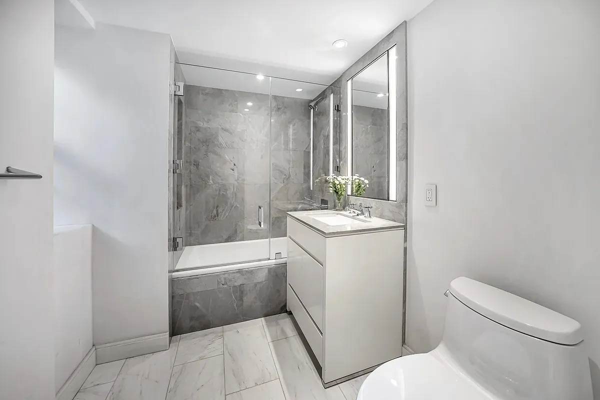 a bathroom with a sink a toilet and tub