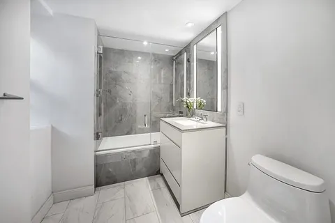 a bathroom with a sink a toilet and tub