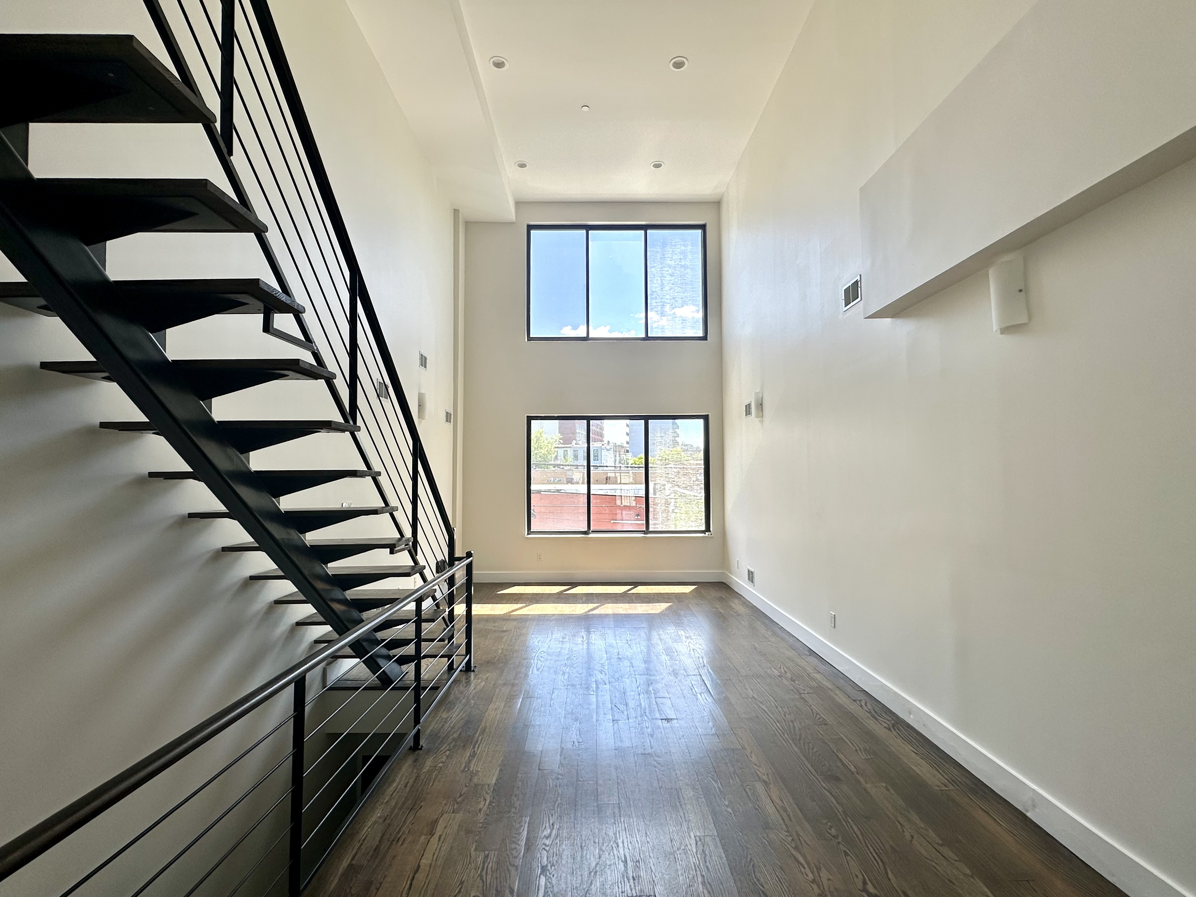 29 MacDougal Street, Unit 2 Brooklyn, NY 11233 - Photo 2 of 14 wooden floor in an empty room with a window