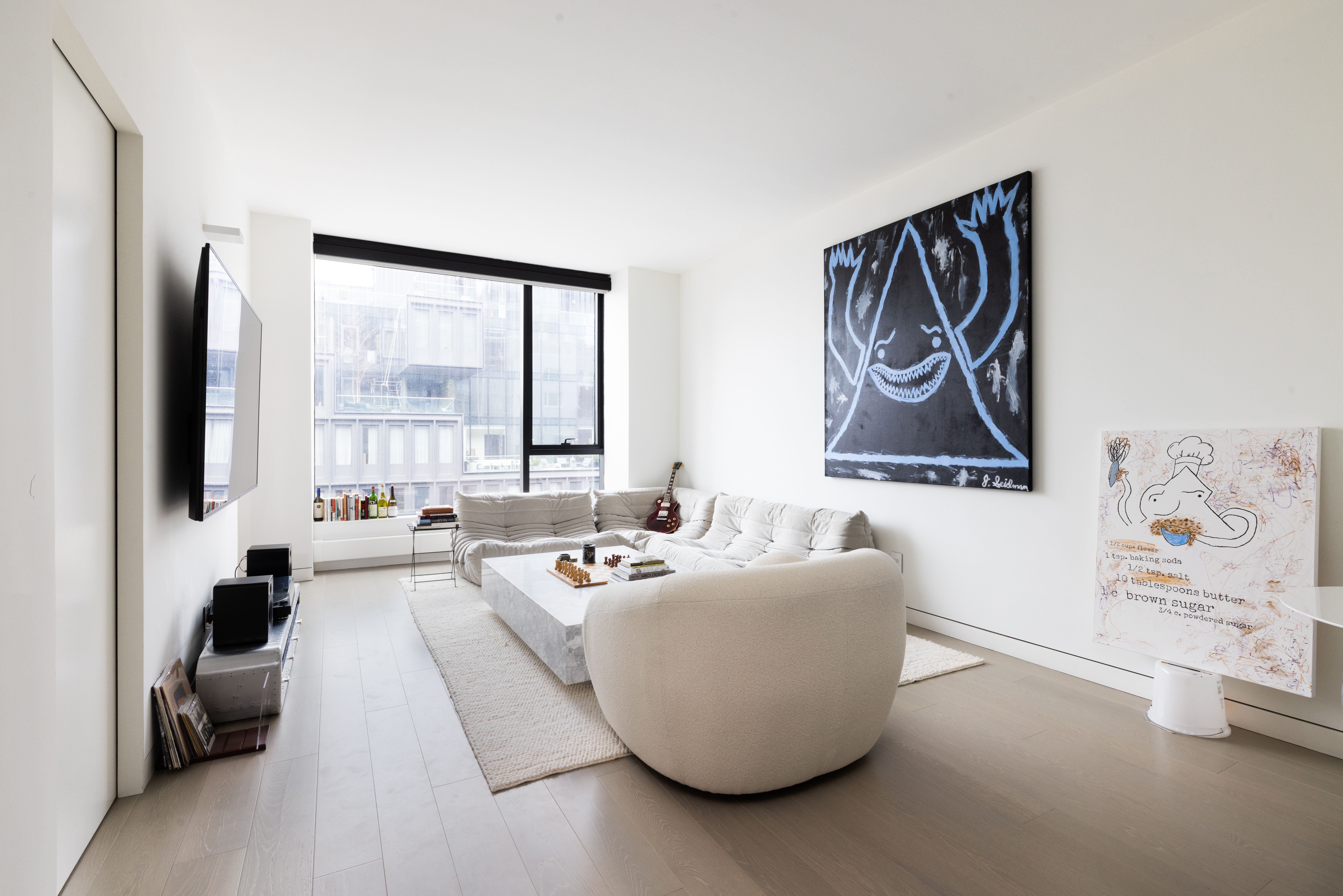 a living room with furniture and large window