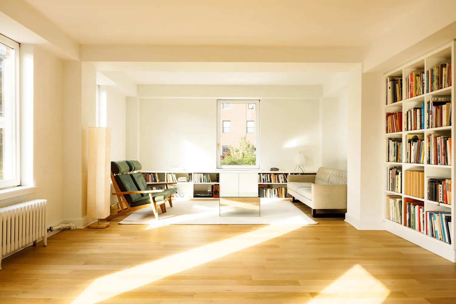 a living room with furniture and a book shelf