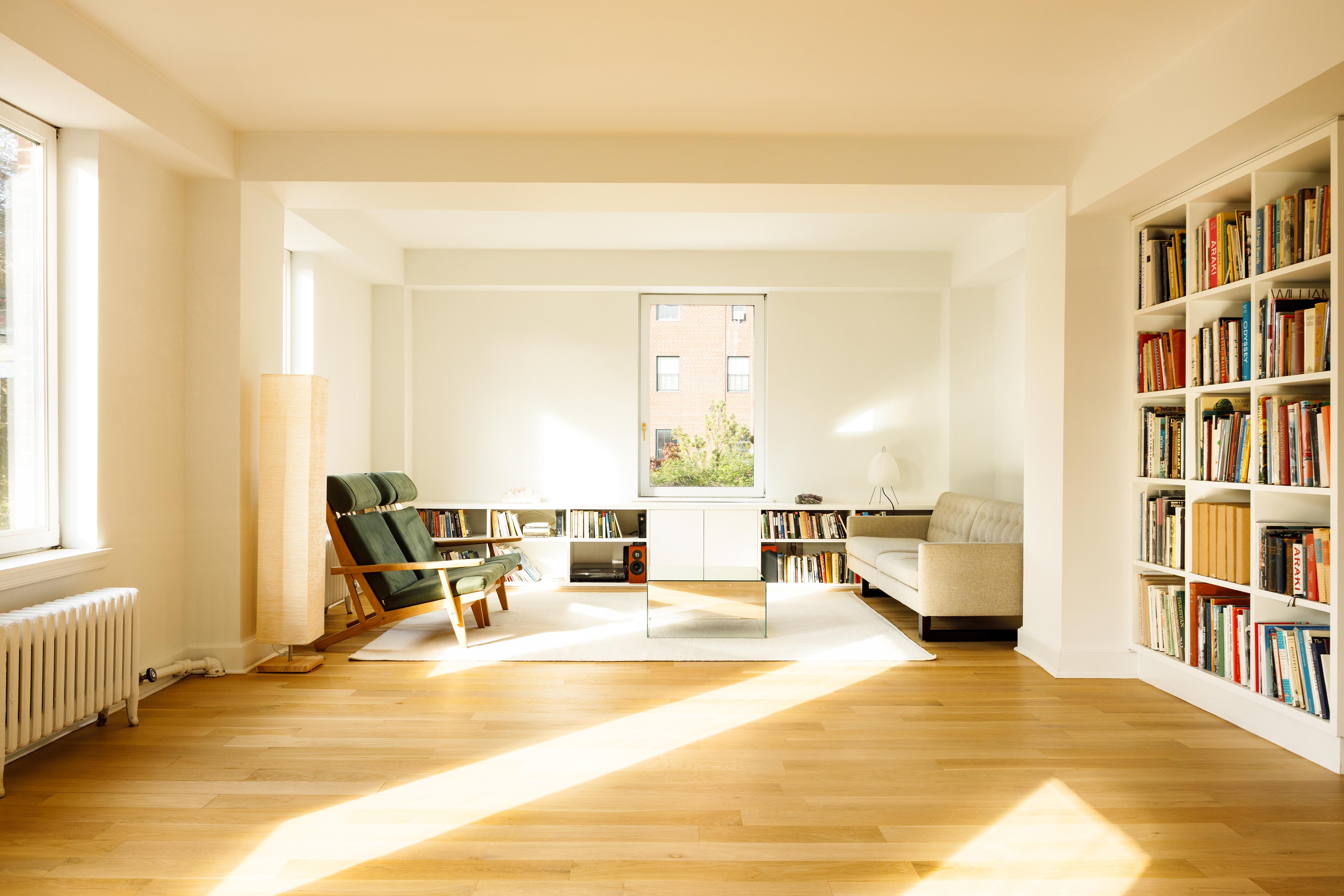 131 Avenue B, Unit 5C Manhattan, NY 10009 - Photo 4 of 18 a living room with furniture and a book shelf