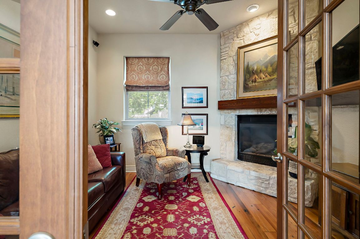 1607 The High Road Austin, TX 78746 - Photo 15 of 28 a living room with furniture and a fireplace
