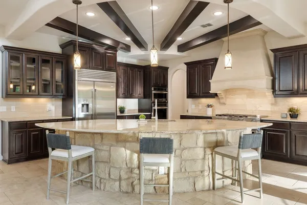 a kitchen with granite countertop a stove and a sink