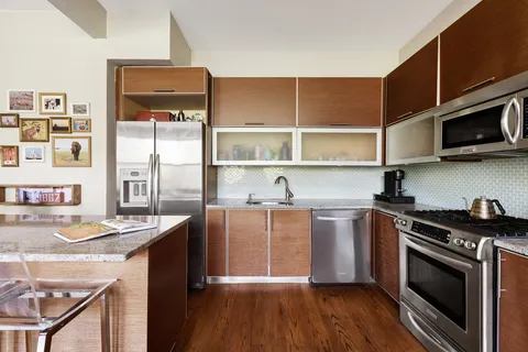 a kitchen with stainless steel appliances granite countertop a stove and a microwave