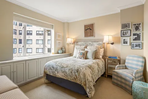 a bedroom with a bed couch and a window