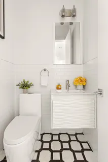 a bathroom with a sink toilet and mirror