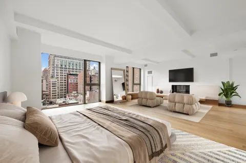 a bedroom with a bed and large window