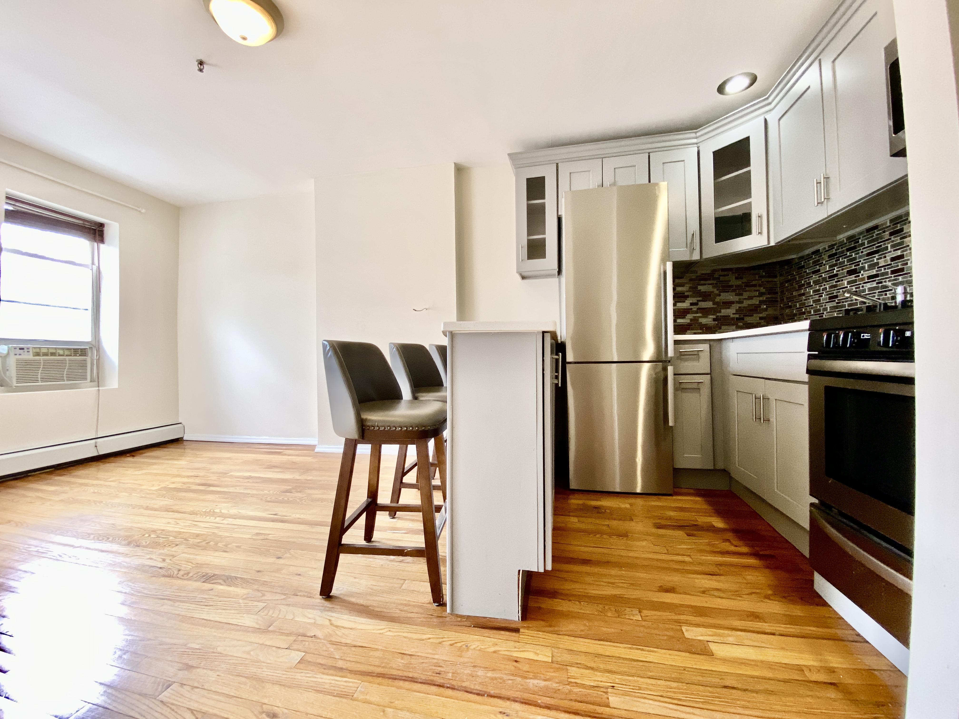373 Gates Avenue, Unit 4 Brooklyn, NY 11216 - Photo 4 of 10 a view of kitchen with furniture and wooden floor