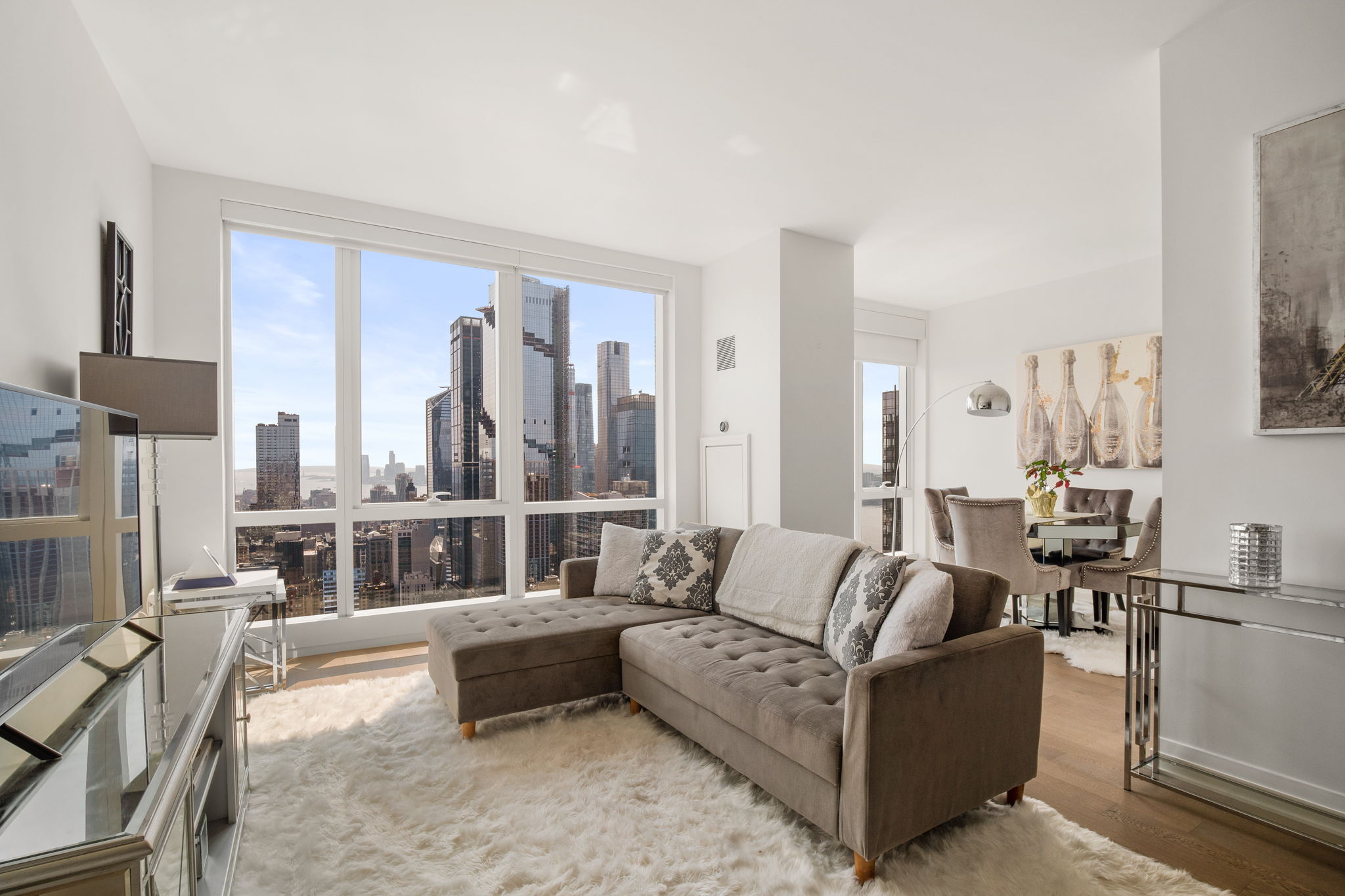 460 West 42nd Street, Unit 55F Manhattan, NY 10036 - Photo 1 of 9 a living room with furniture and a large window