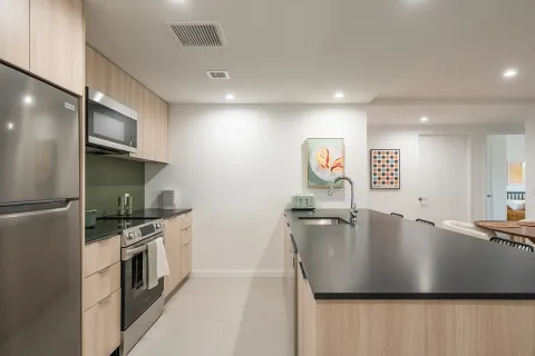 a kitchen with stainless steel appliances granite countertop a sink a stove and a refrigerator