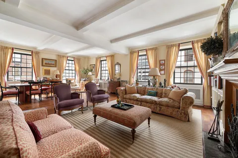 a living room with furniture fireplace and a large window