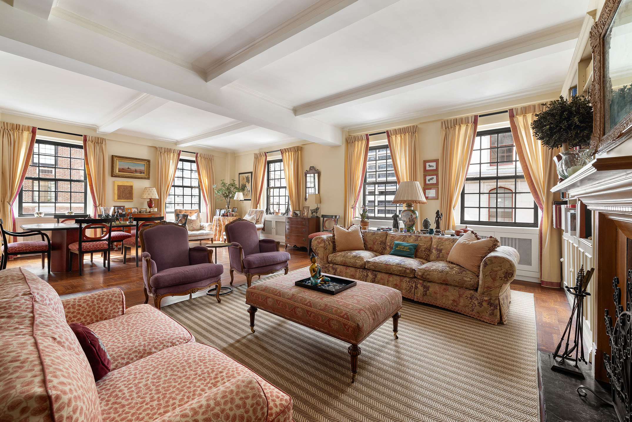 129 East 69th Street, Unit 8/9A Manhattan, NY 10021 - Photo 2 of 16 a living room with furniture fireplace and a large window