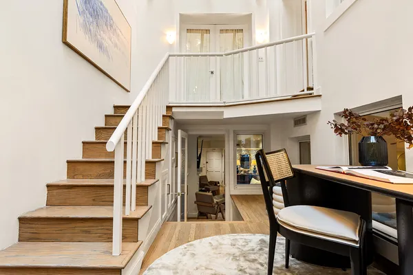 a view of entryway and hall with wooden floor