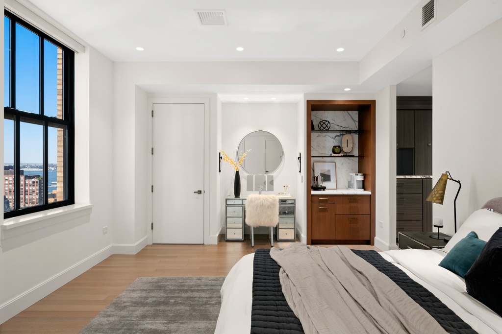 100 Barclay Street, Unit 21AD Manhattan, NY 10007 - Photo 11 of 40 a bedroom with a bed and wooden floor