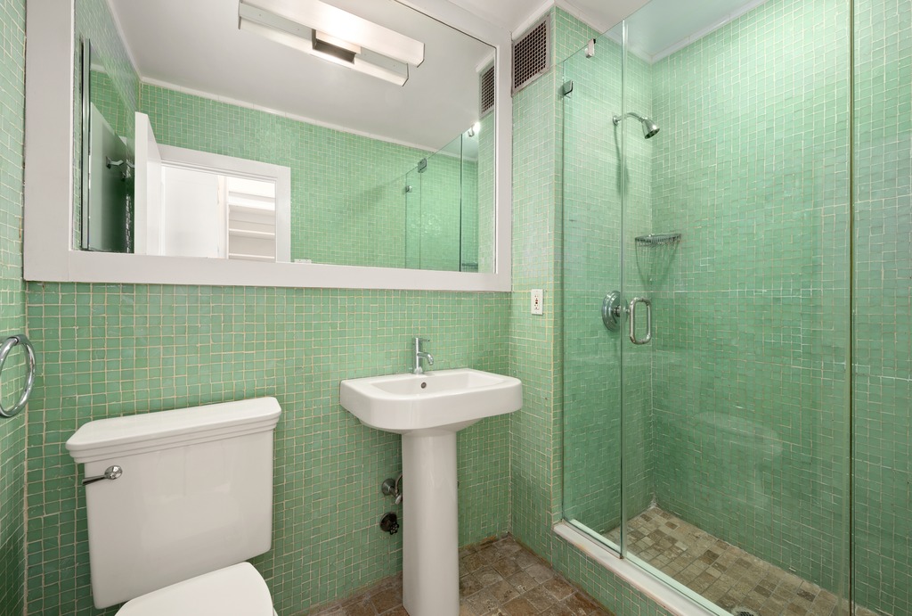520 LaGuardia Place, Unit 2N Manhattan, NY 10012 - Photo 14 of 20 a bathroom with a sink mirror toilet and shower