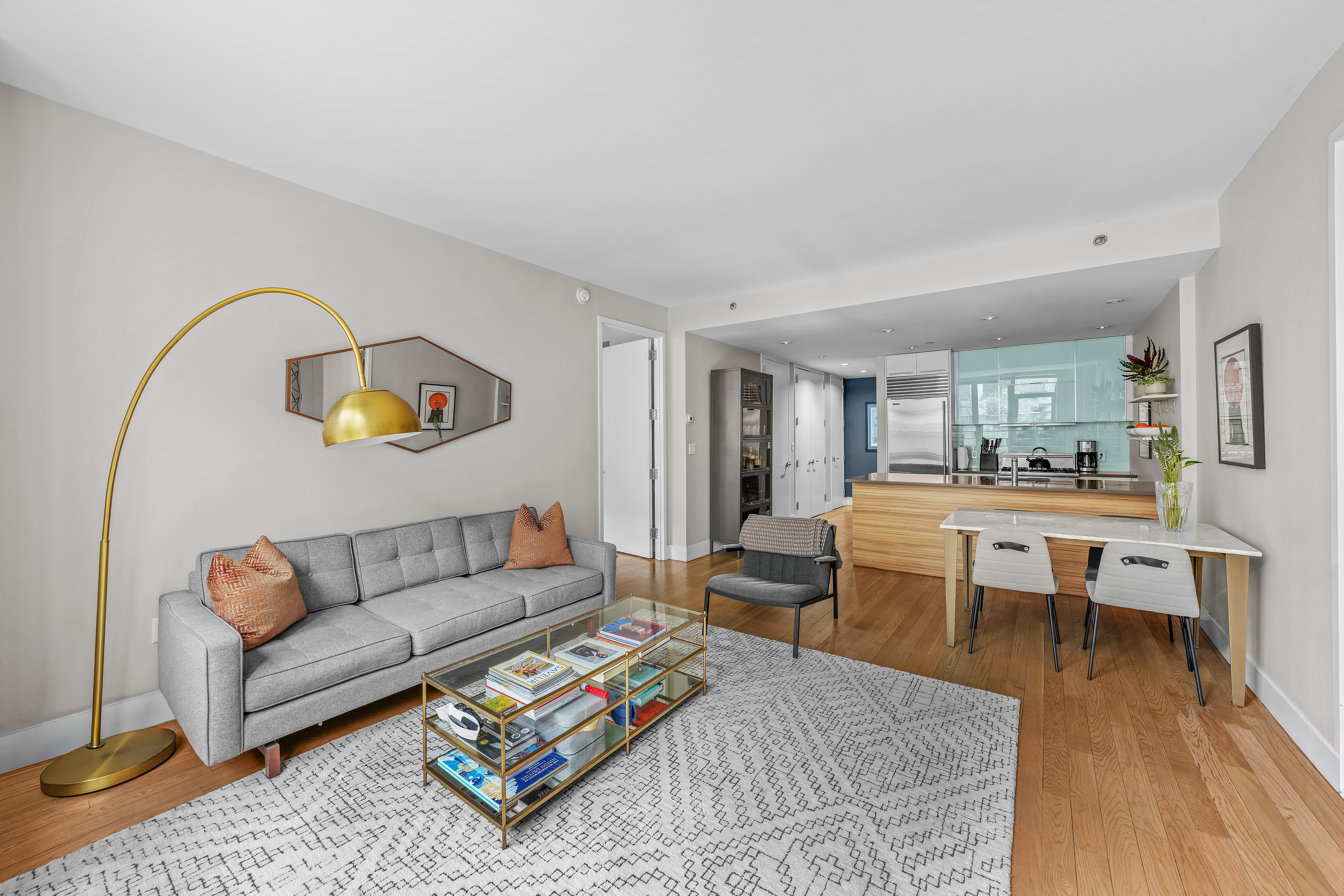 117 West 123rd Street, Unit 1B Manhattan, NY 10027 - Photo 5 of 25 a living room with furniture and a wooden floor