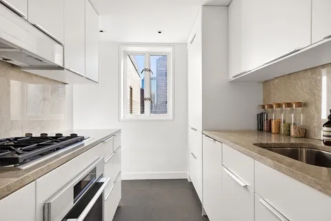 a kitchen that has a sink and a stove