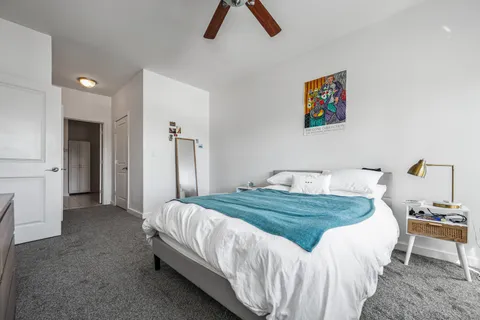 a bedroom with a bed and a chandelier