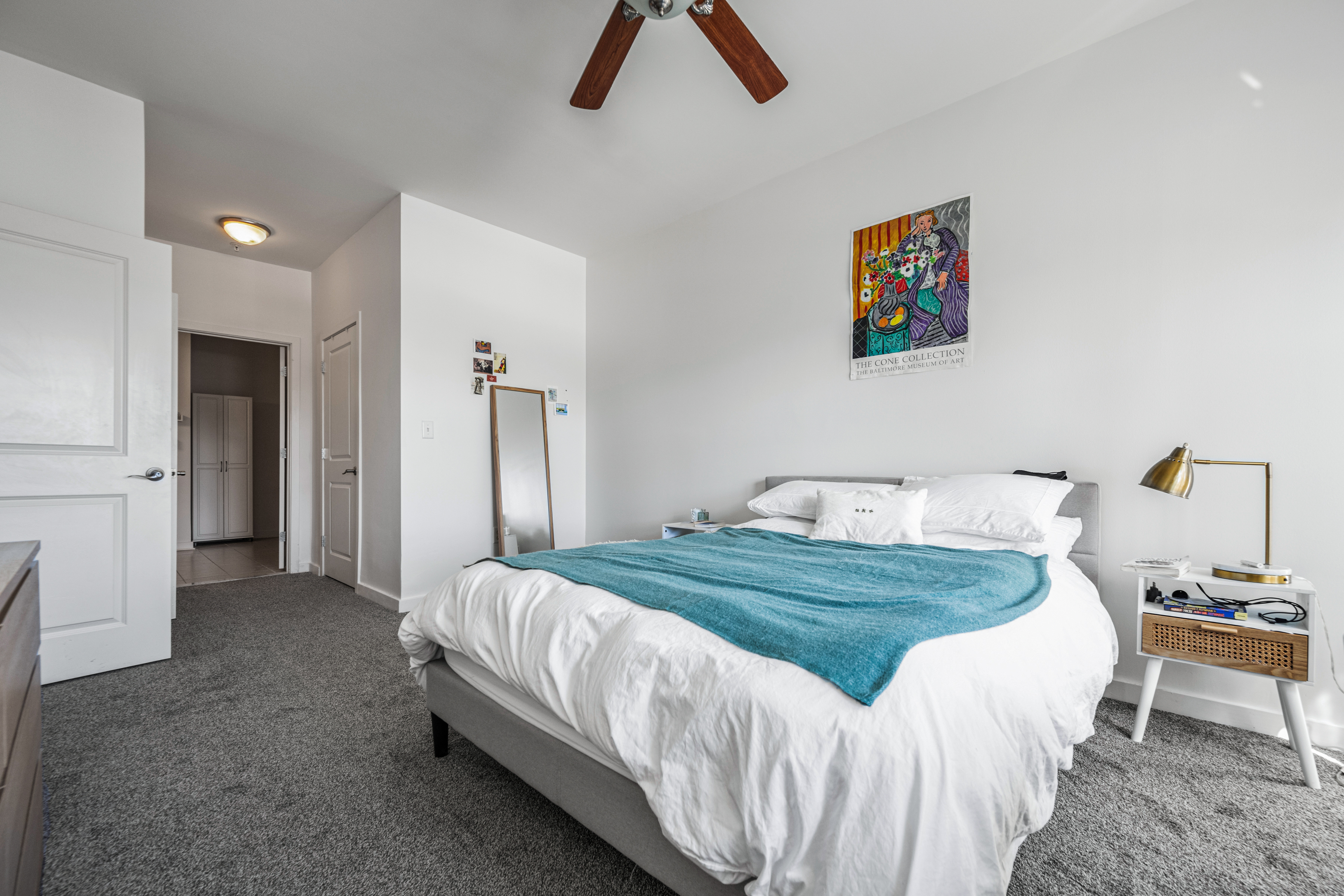 3201 St Paul Street, Unit 310 Baltimore, MD 21218 - Photo 5 of 20 a bedroom with a bed and a chandelier