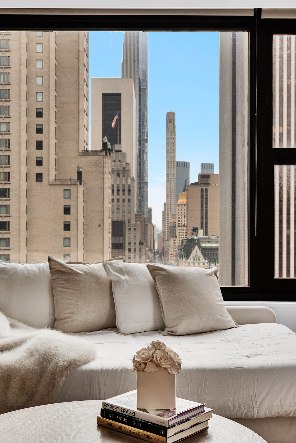 117 East 57th Street, Unit 35D Manhattan, NY 10022 - Photo 5 of 30 a living room with furniture and a fireplace