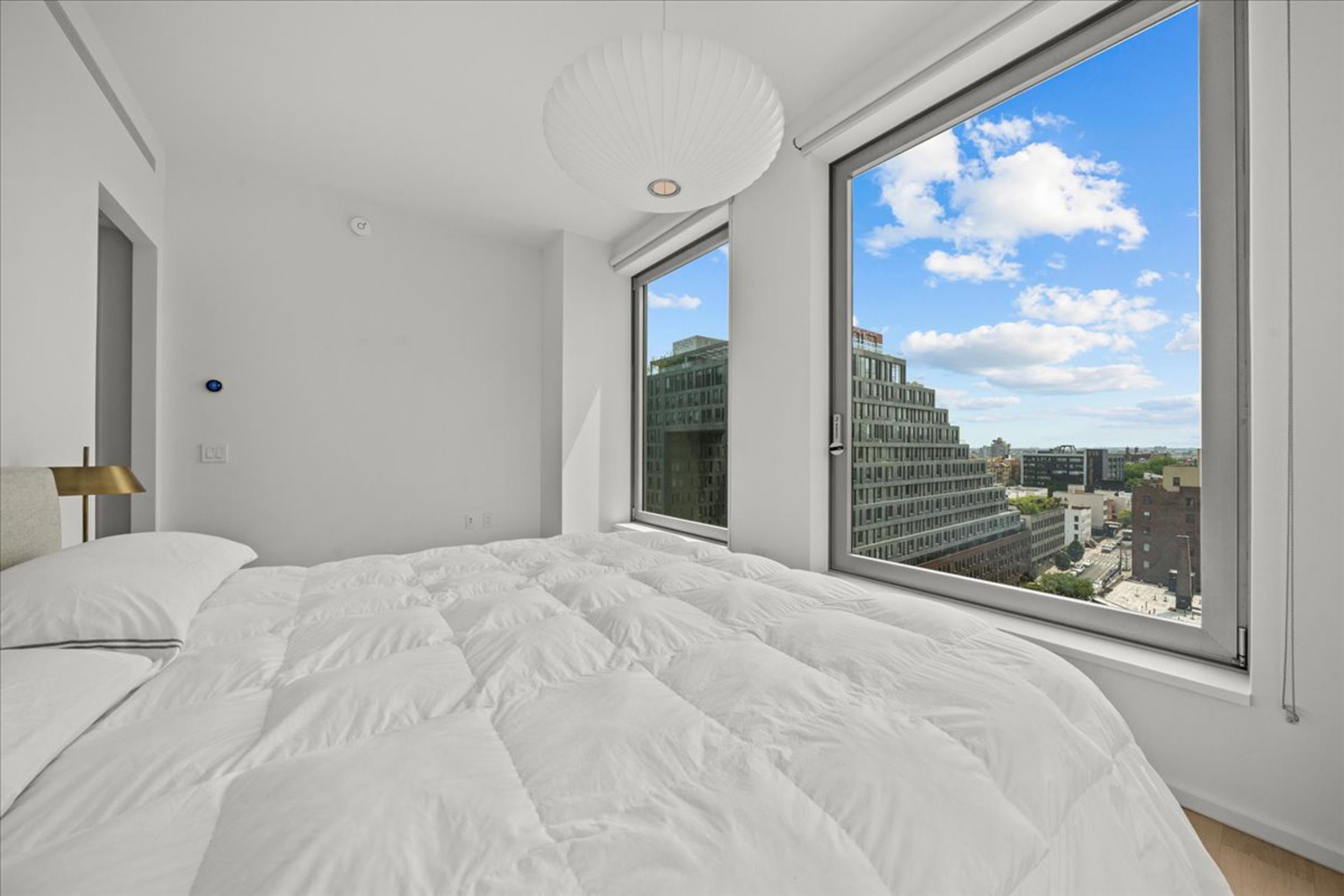 8 South 4th Street, Unit 15D Brooklyn, NY 11249 - Photo 5 of 29 a view of a bedroom with a large window and bed