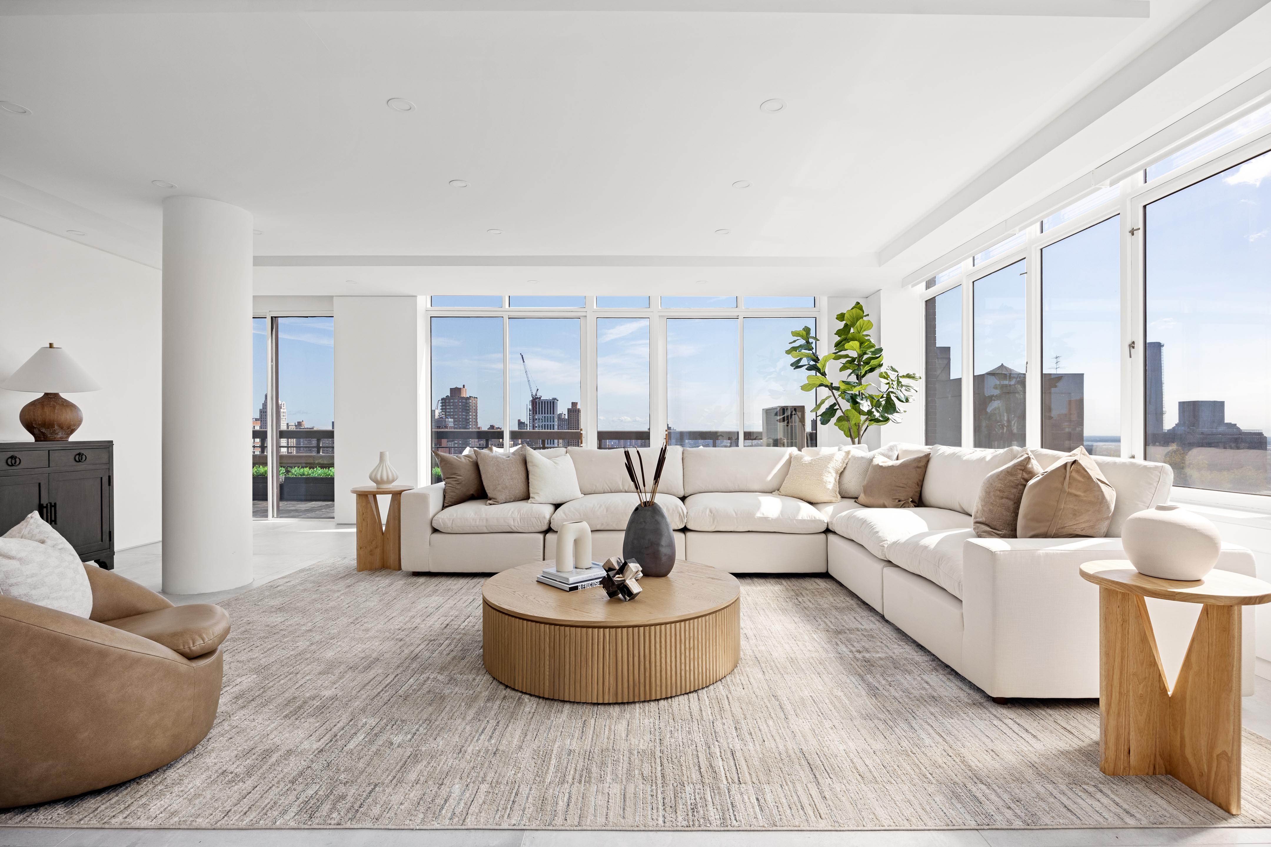 422 East 72nd Street, Unit 37AD Manhattan, NY 10021 - Photo 2 of 38 a living room with furniture and a large window