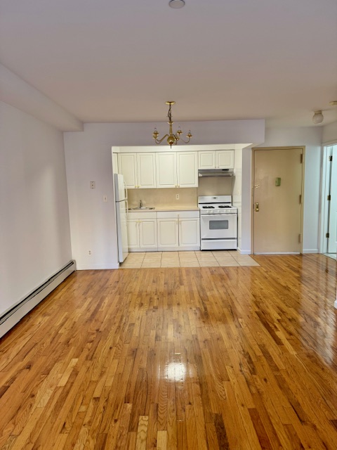30-18 33rd Street, Unit 2F Queens, NY 11102 - Photo 2 of 6 a big room with wooden floor and window