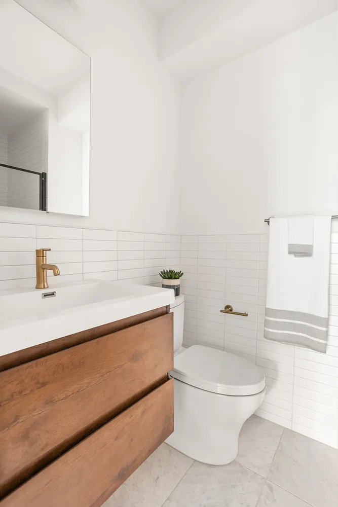 a white toilet sitting next to a bathroom sink