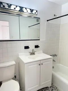 a bathroom with a sink a toilet and a bathtub
