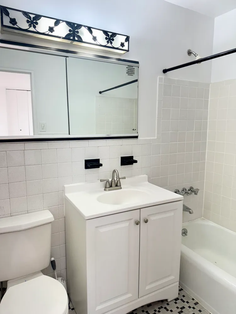 a bathroom with a sink a toilet and a bathtub