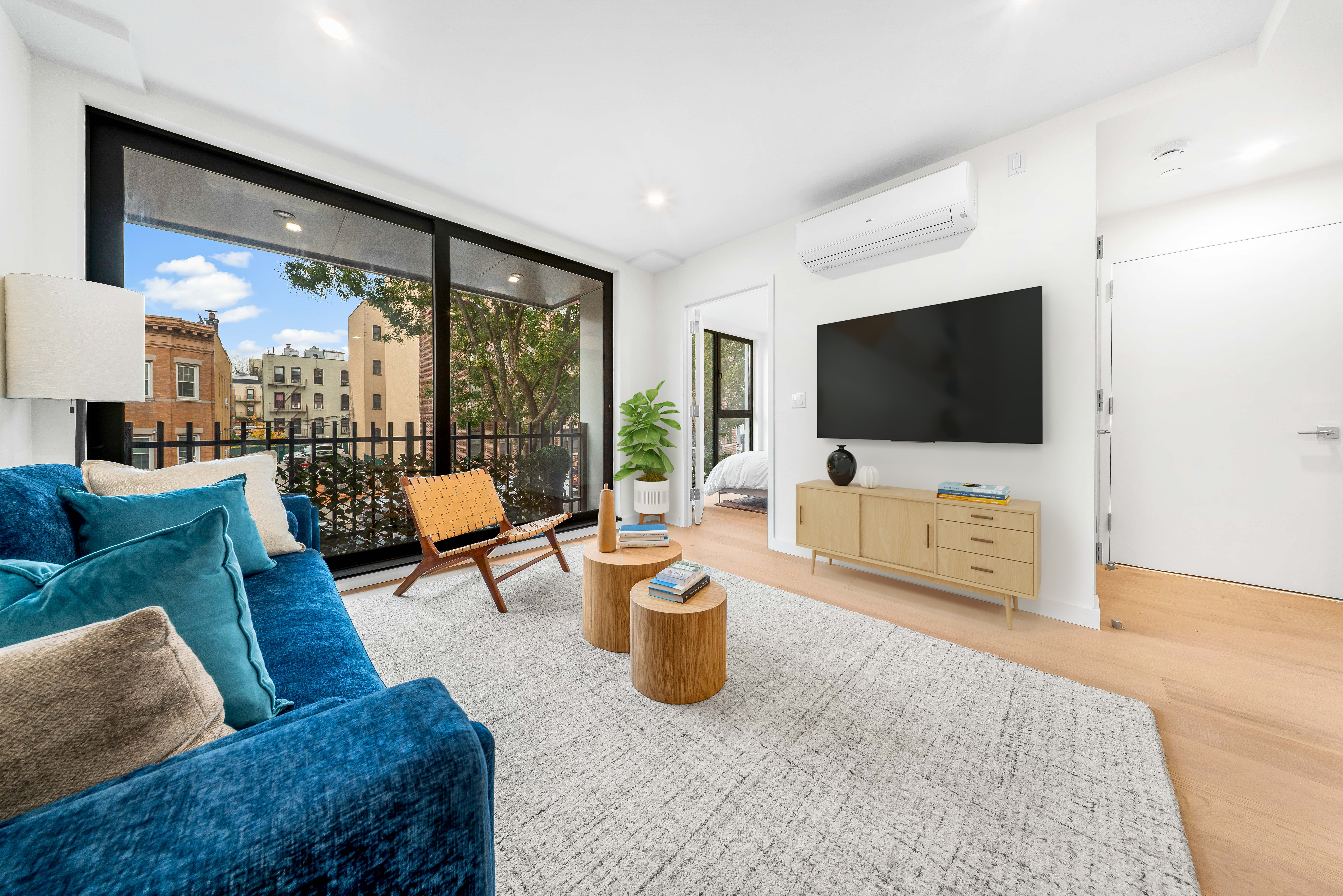 30-24 32nd Street, Unit 3A Queens, NY 11102 - Photo 6 of 18 a living room with furniture and a flat screen tv