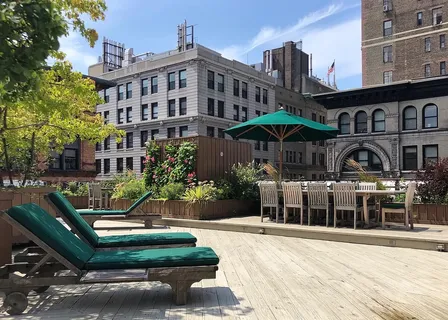 a view of a backyard with sitting area