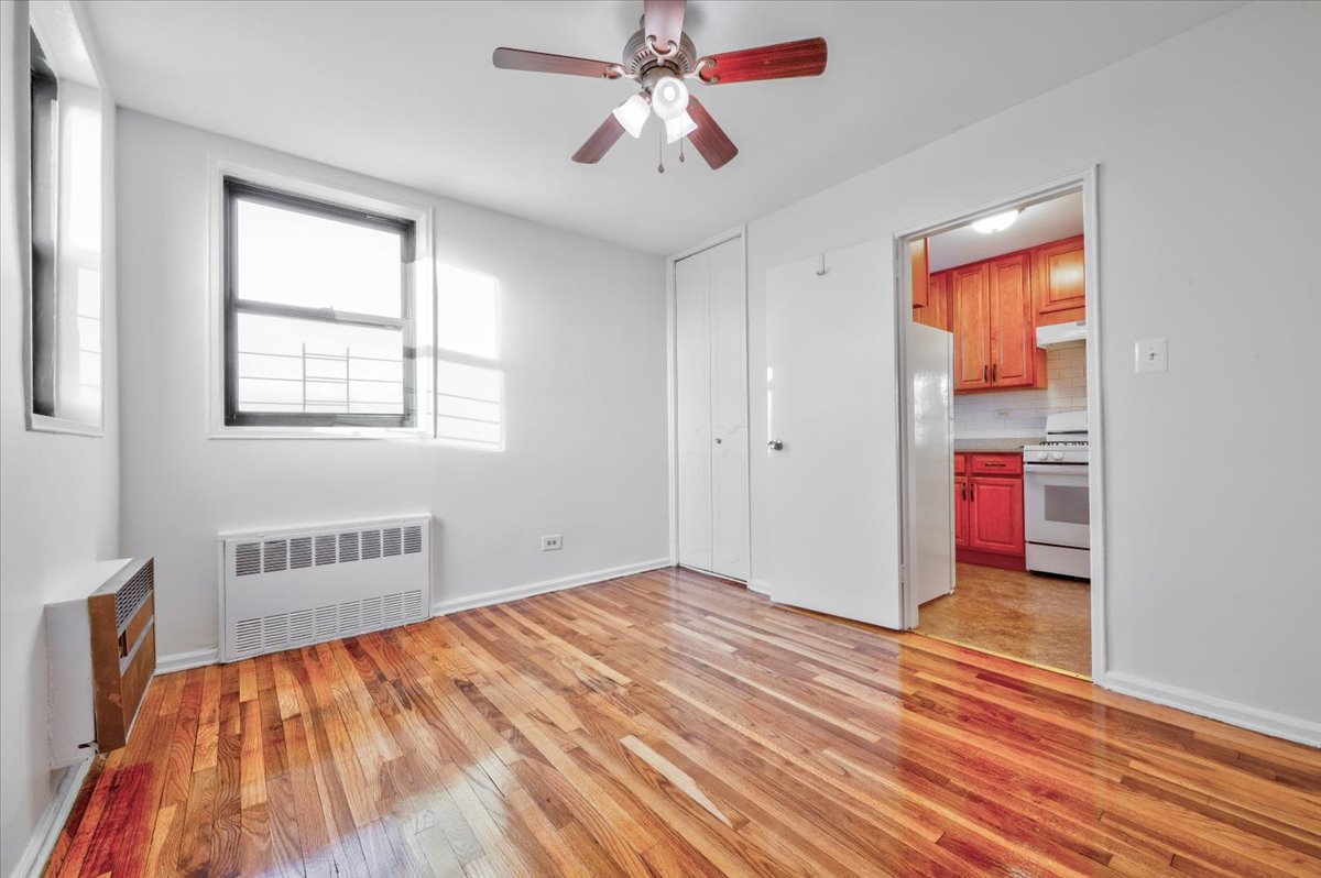 1270 East 51st Street, Unit 6X Brooklyn, NY 11234 - Photo 6 of 17 an empty room with wooden floor and windows