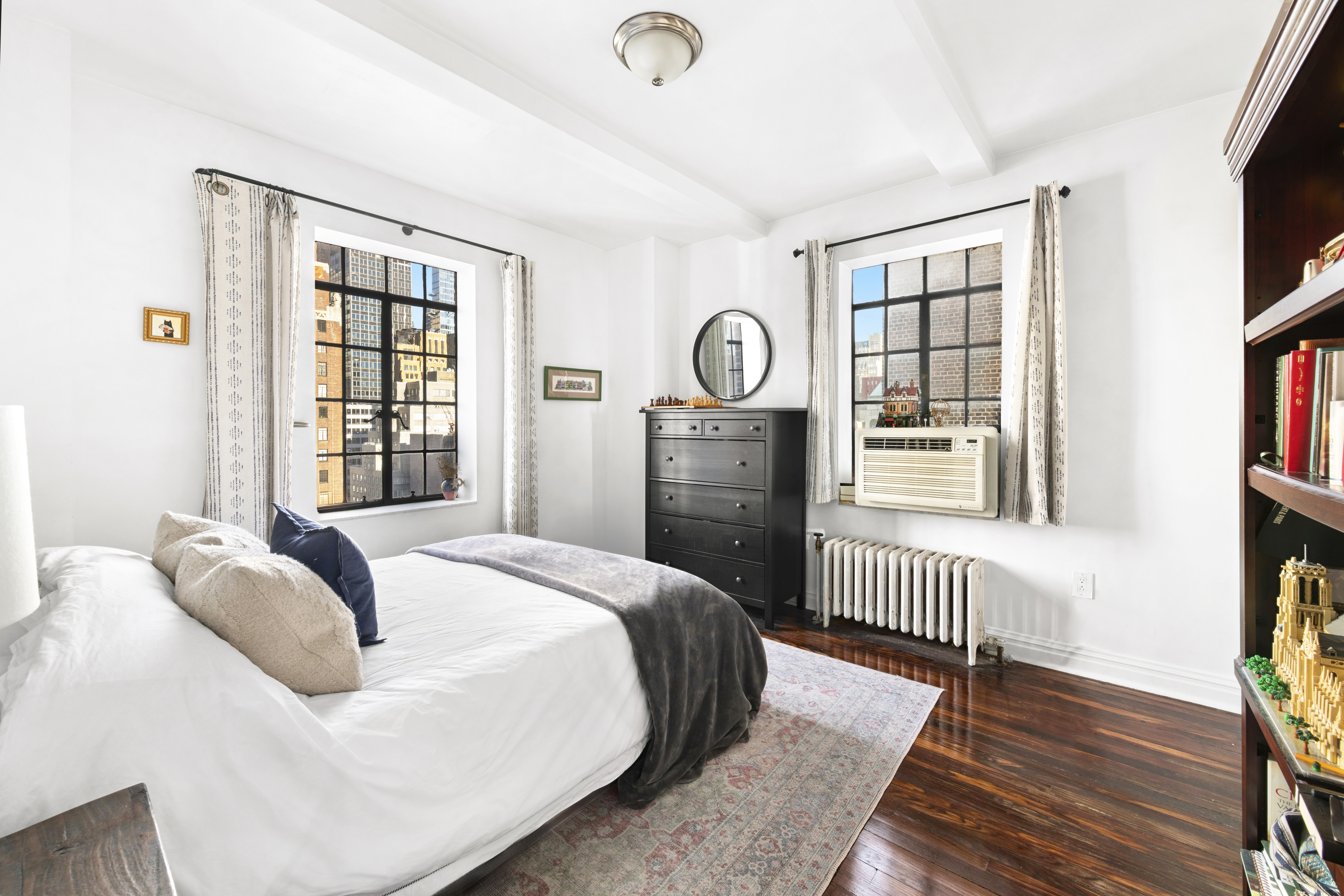 25 Tudor City Place, Unit 1611 Manhattan, NY 10017 - Photo 4 of 15 a bedroom with a bed and a window