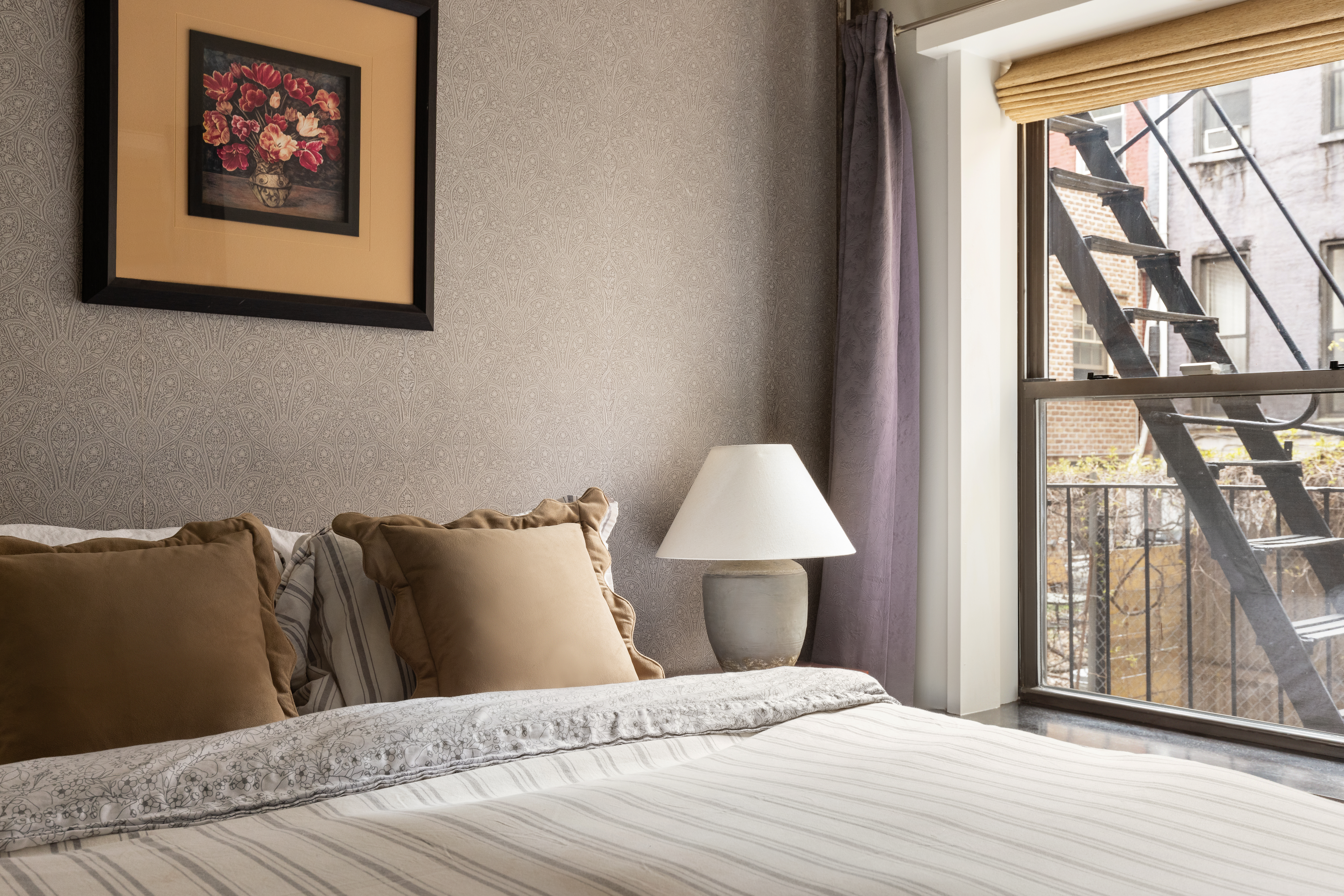 130 West 16th Street, Unit 6 Manhattan, NY 10011 - Photo 5 of 9 a bedroom with a bed and a painting on the wall