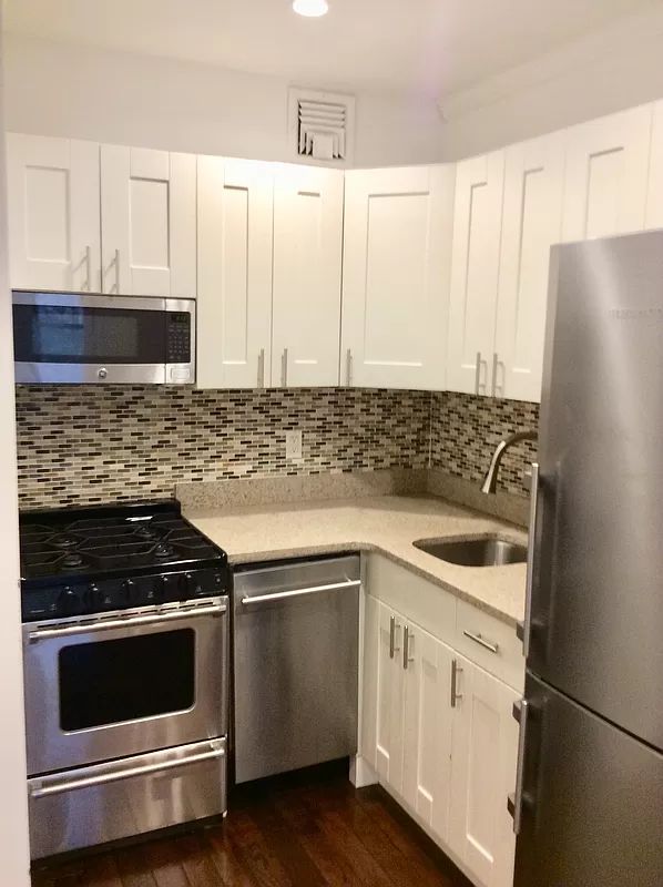 328 West 19th Street, Unit 1B Manhattan, NY 10011 - Photo 7 of 11 a kitchen with appliances cabinets and a sink
