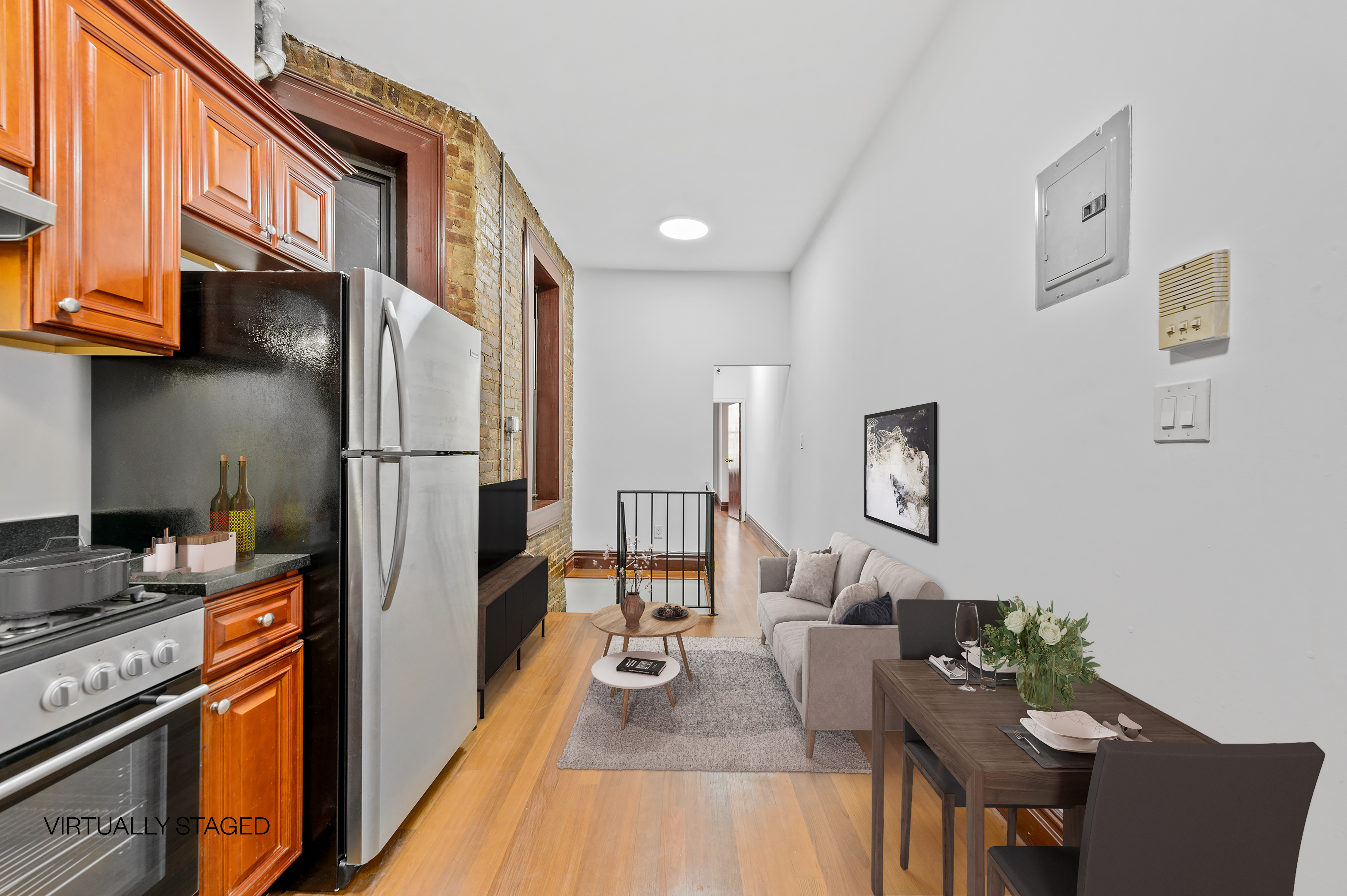 a kitchen with stainless steel appliances granite countertop a refrigerator a stove top oven a dining table and chairs with wooden floor